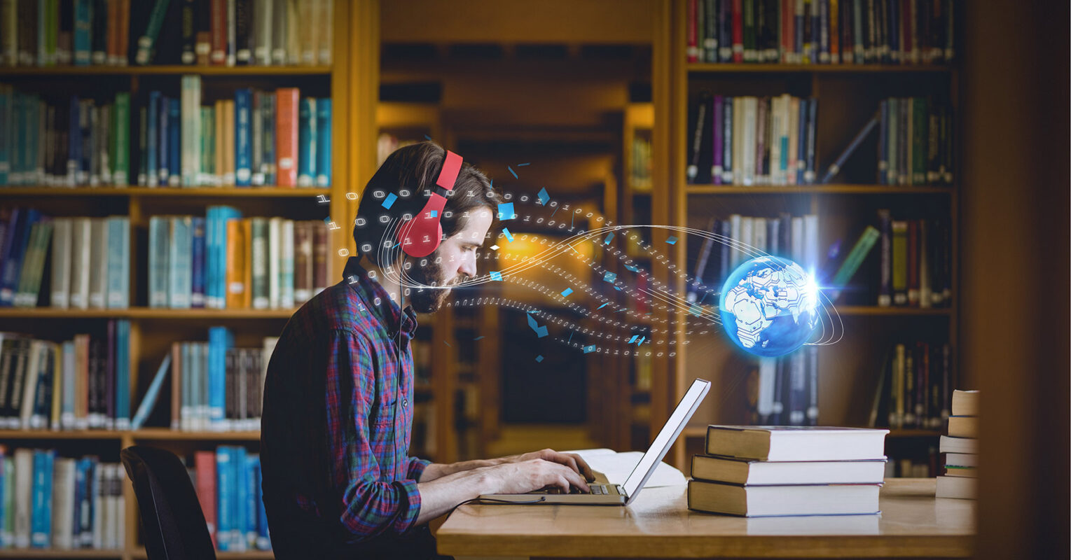 Student in library using laptop with globe transmitting data